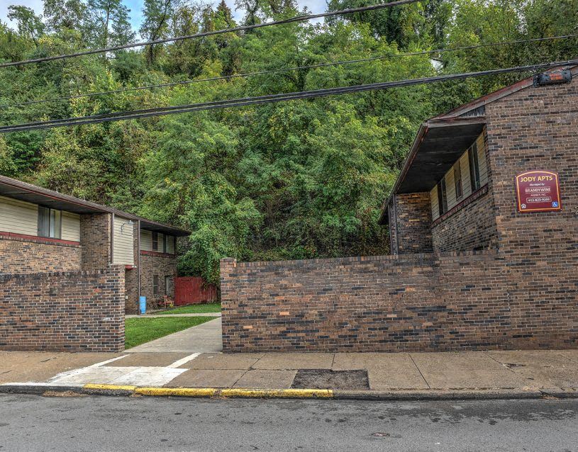 a brick building with a red sign on the side of it