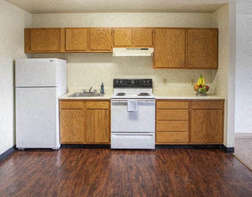 a kitchen with a stove and a refrigerator