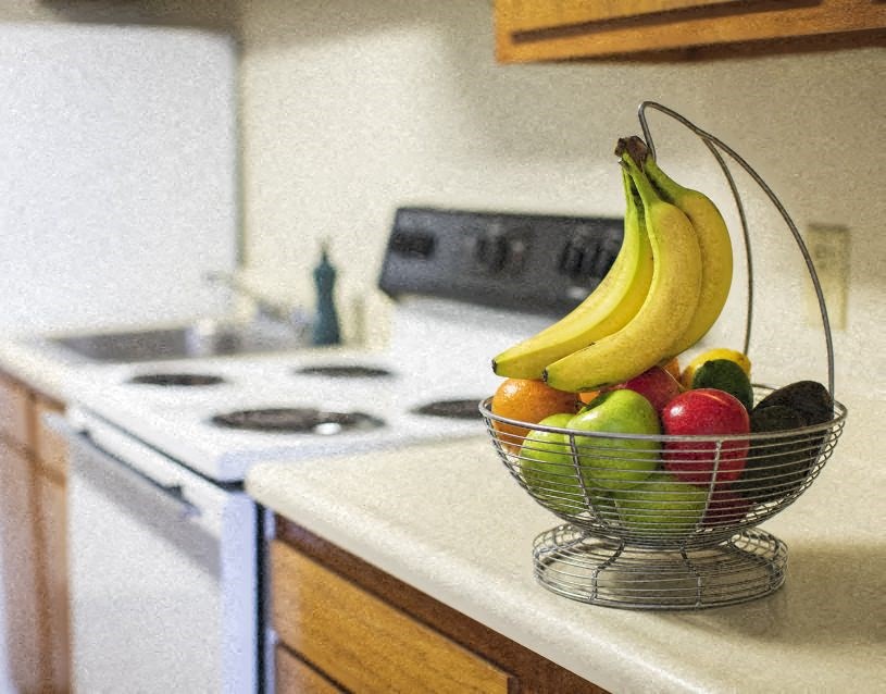 a bowl of fruit sitting on a kitchen counter