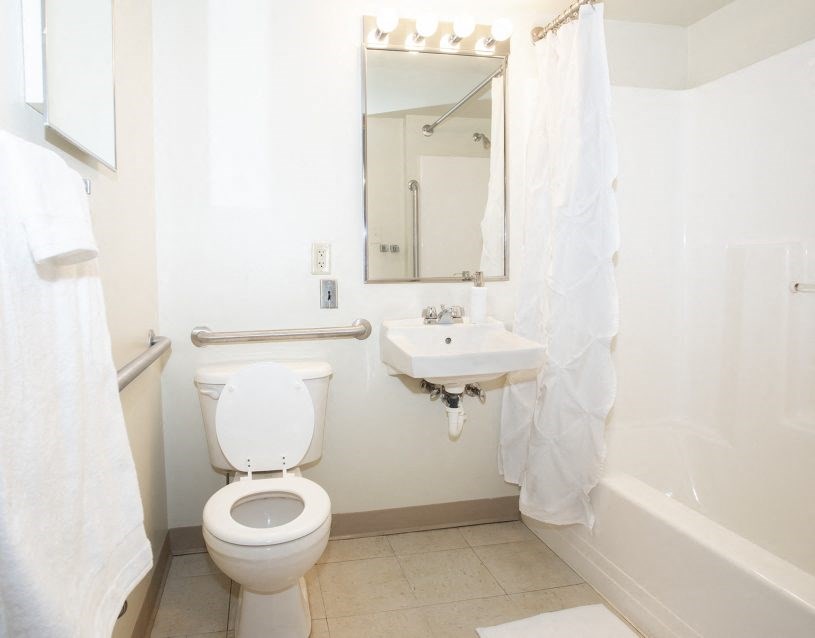 a bathroom with a toilet and a sink and a mirror