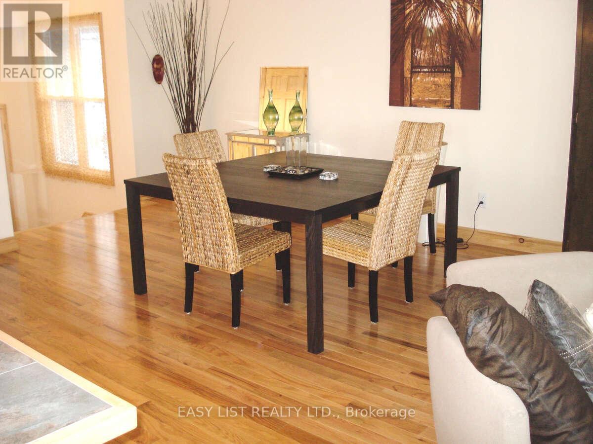 A dining room with a table and chairs.