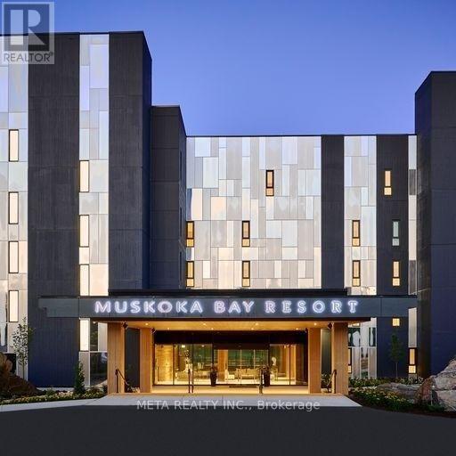 The Muskoka Bay Resort is a modern building with a glass facade and a welcoming entrance.