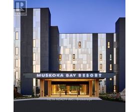 The Muskoka Bay Resort is a modern building with a glass facade and a welcoming entrance.