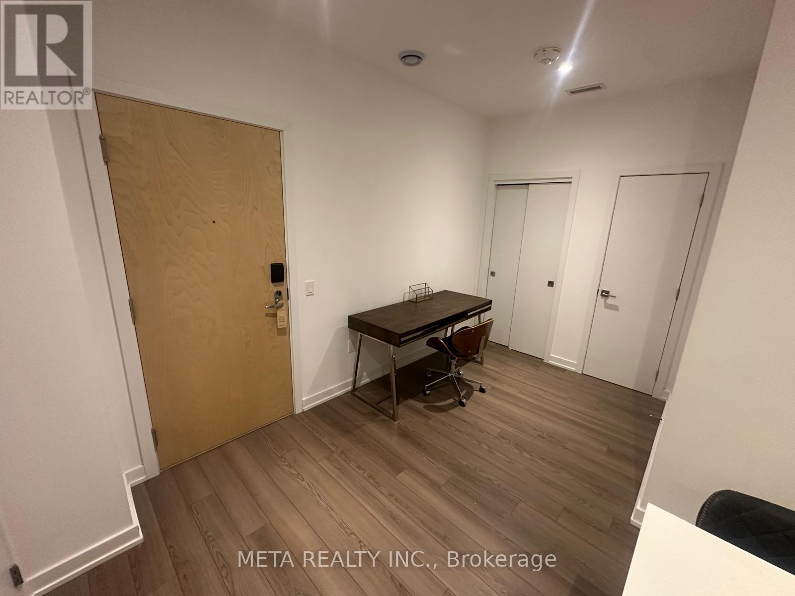 A room with a desk and chairs is for sale.