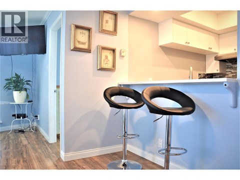 Two black bar stools in front of a blue wall.