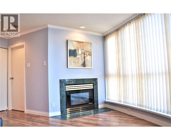 A living room with a fireplace and a painting on the wall.