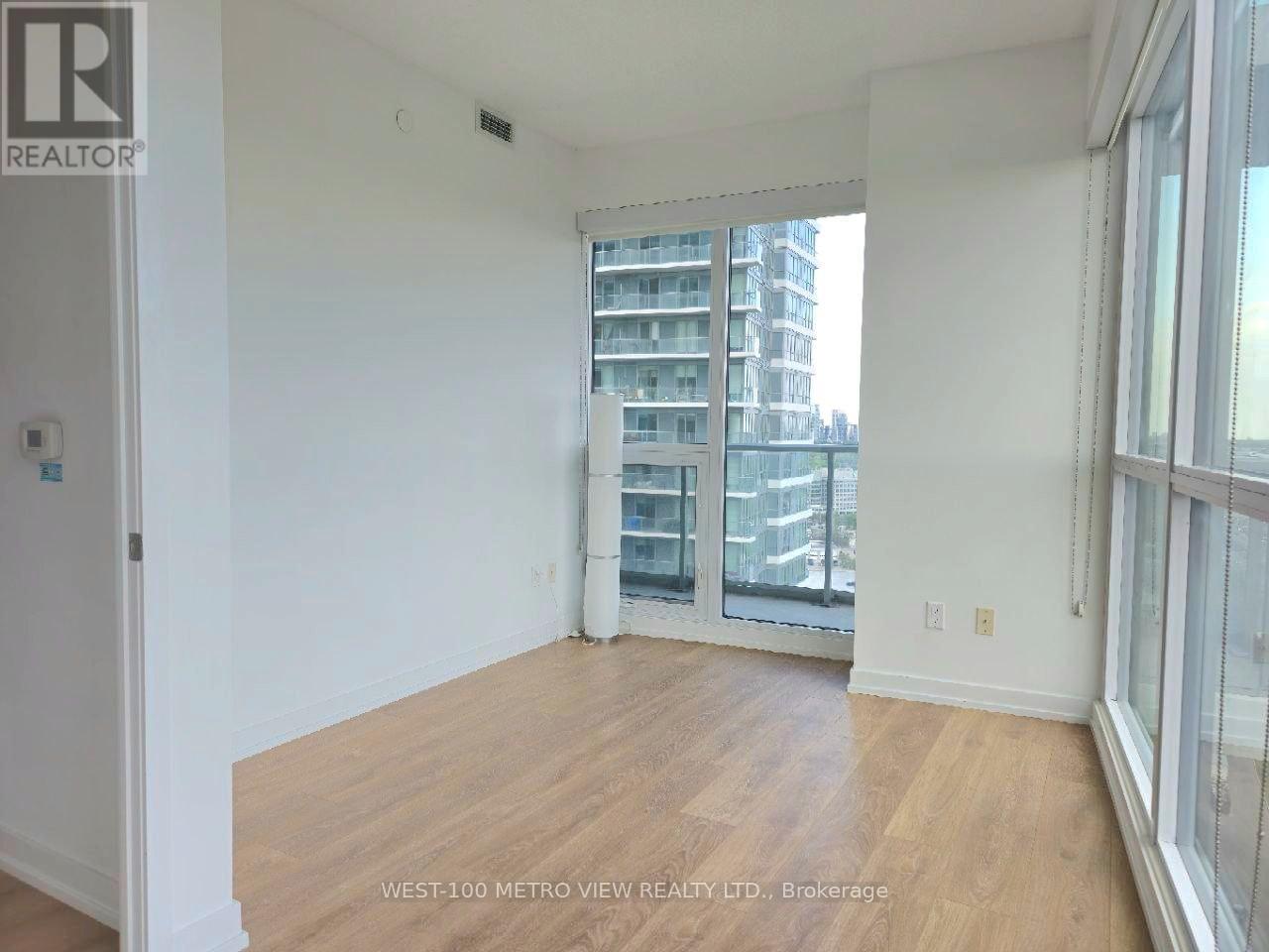 A room with a view of a building across the street.