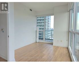 A room with a view of a building across the street.