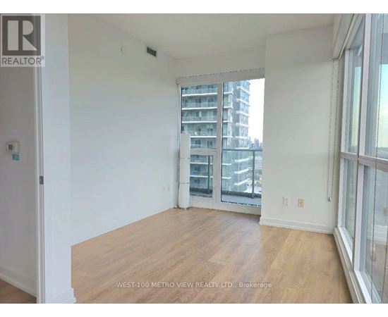 A room with a view of a building across the street.