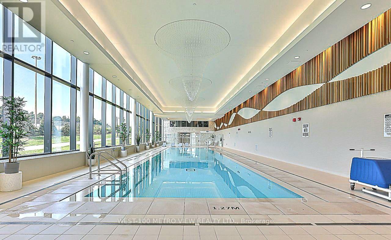 A large indoor swimming pool with a glass bottom.