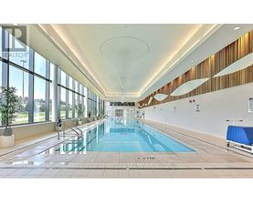 A large indoor swimming pool with a glass bottom.