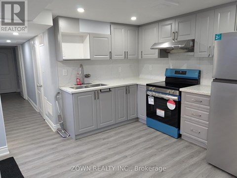 A kitchen with white cabinets and a blue island.