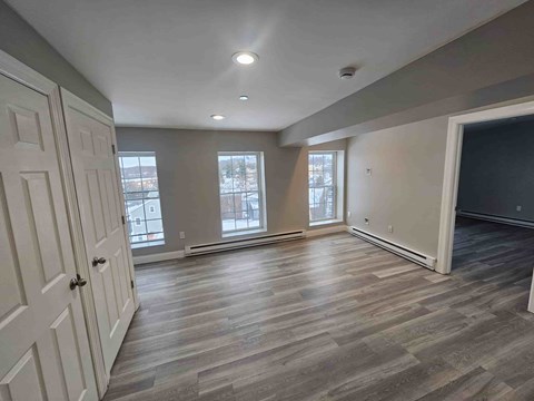 A room with a wooden floor and a large window.