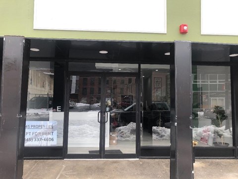 The entrance to a building with a sign that says "45 properties for rent" and a phone number.