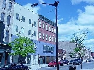 A street with cars and buildings on either side.
