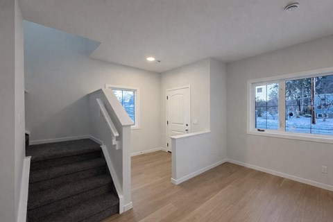 A room with a staircase leading to the upper floor.