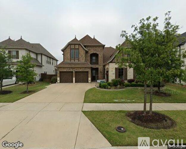 A large house with a driveway in front.