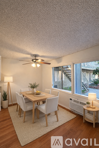 A dining room with a table set for four.