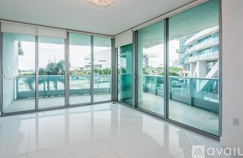 A spacious room with large glass doors and a view of the outside.
