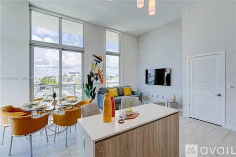 A modern kitchen with a dining table and chairs.