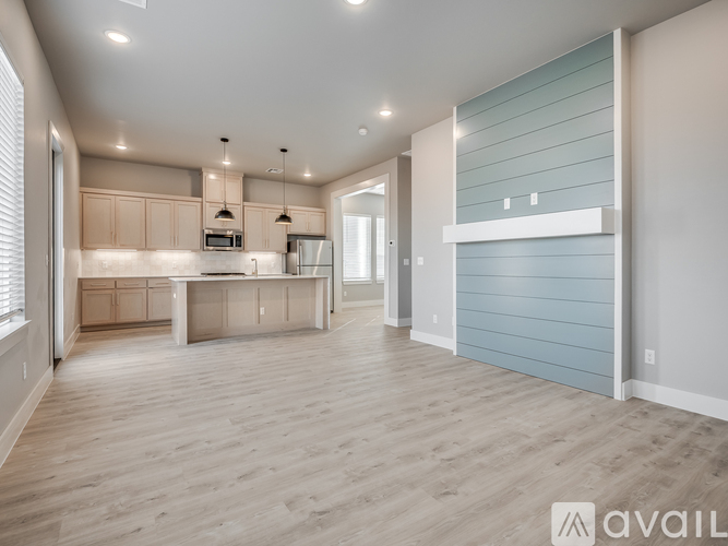 A spacious kitchen with wooden floors and a large island.