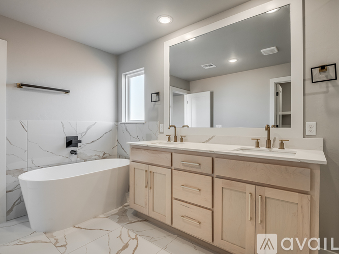 A bathroom with a marble tub and sink.