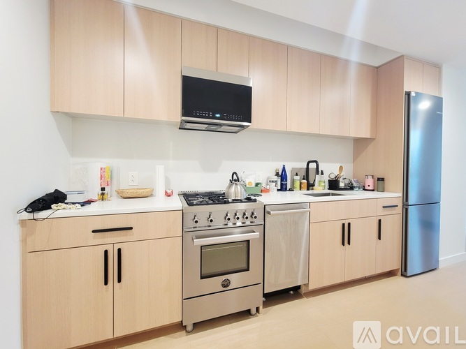 A kitchen with wooden cabinets and stainless steel appliances.