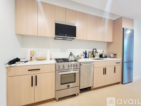 A kitchen with wooden cabinets and stainless steel appliances.