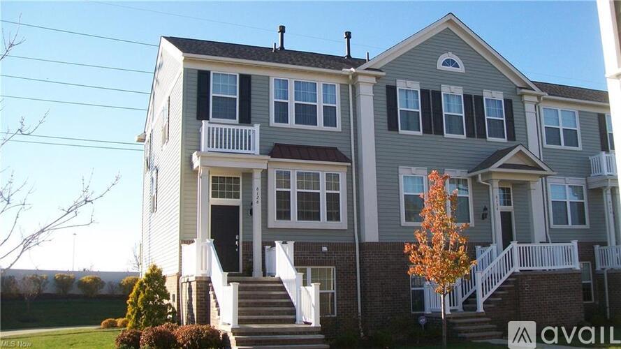 A two-story house with a balcony on the second floor.