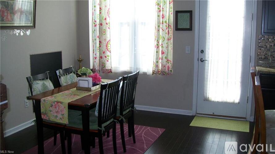 A dining room with a table set for four.