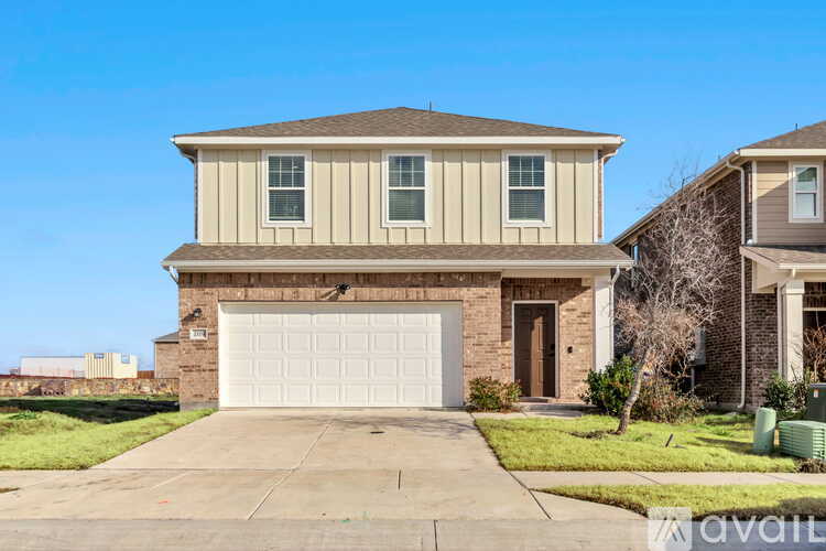 A two-story house with a garage is available for sale.