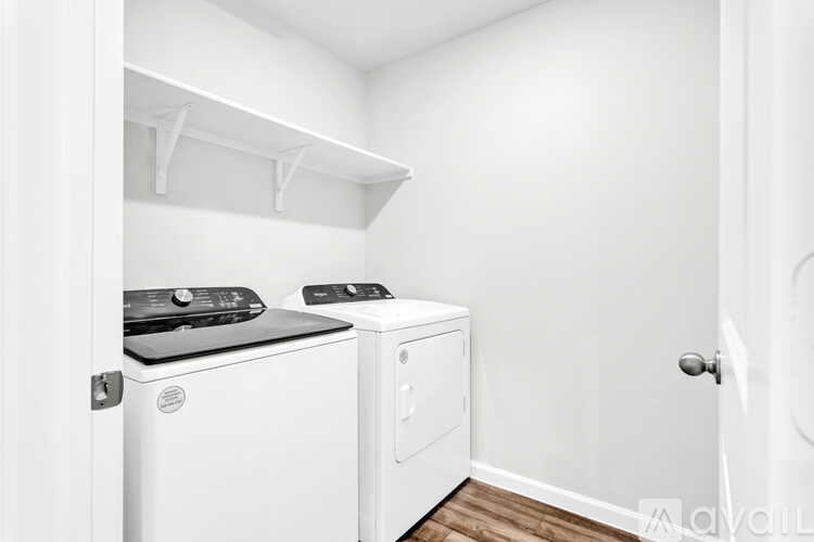 A small laundry room with a washer and dryer.