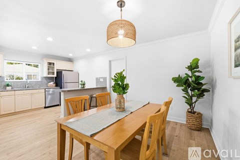 A dining room with a wooden table and chairs.