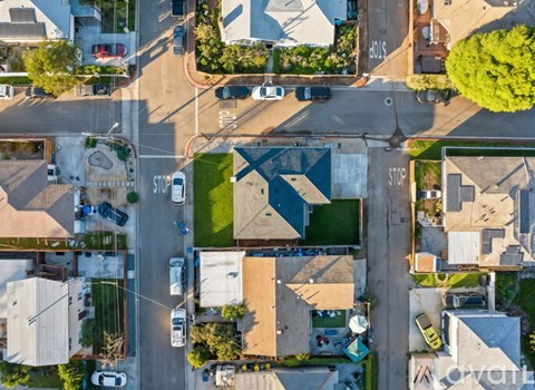 An aerial view of a street with cars and buildings.