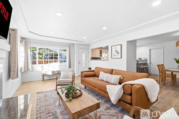 A living room with a brown couch and a wooden coffee table.