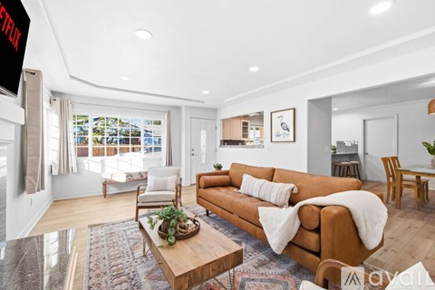 A living room with a brown couch and a wooden coffee table.