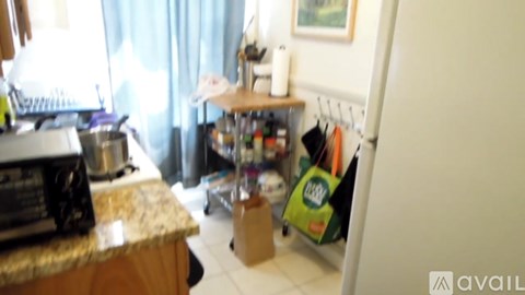 A kitchen with a microwave, oven, and a refrigerator.