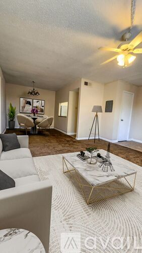 A living room with a white couch and a coffee table.