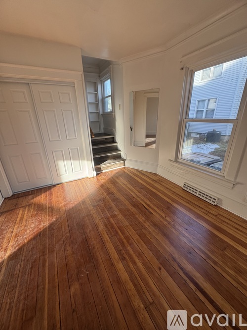 A room with wooden floors and white walls.