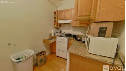 A kitchen with wooden cabinets and a white fridge.