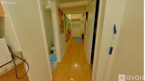 A long hallway with a blue mat on the floor.
