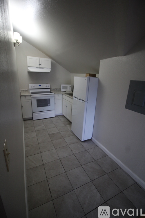 A kitchen with white appliances and a white refrigerator.