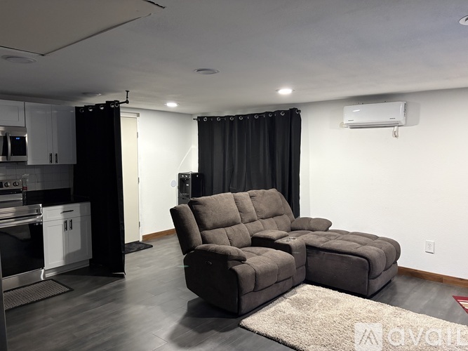 A grey reclining sofa in a modern living room.