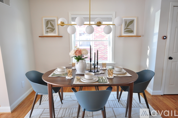 A dining room with a round table set for four.