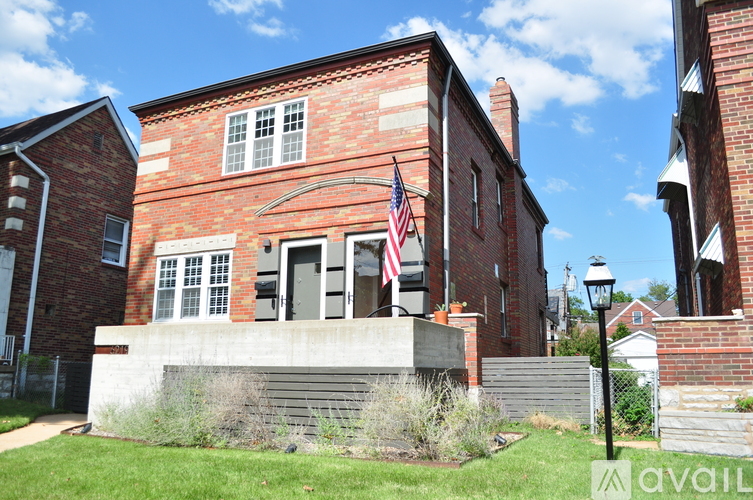 A red brick building with a flag on it.