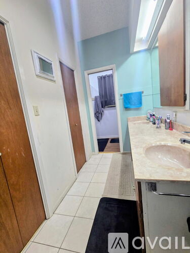 A bedroom with a bed, dresser, and mirror.
