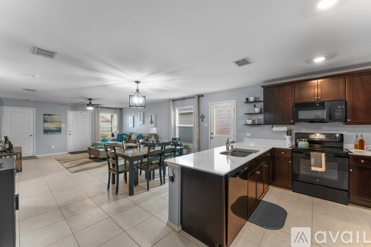 A modern kitchen with a dining table and chairs.