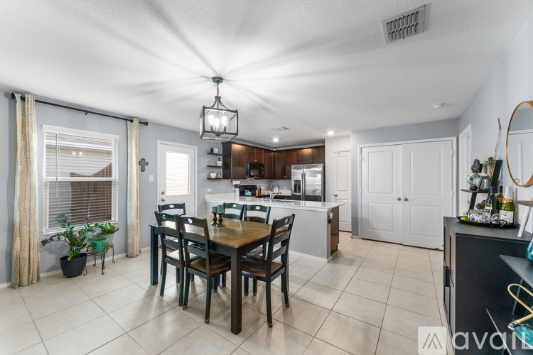A dining room with a table set for four.