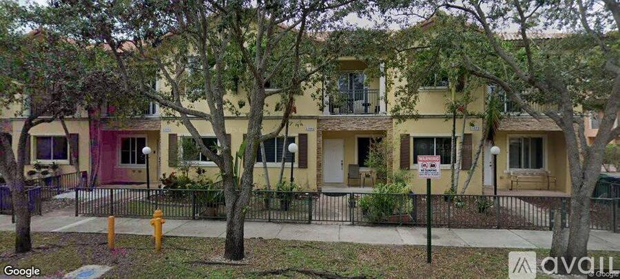 A yellow building with a red door and a sign that says "AVAILABLE".
