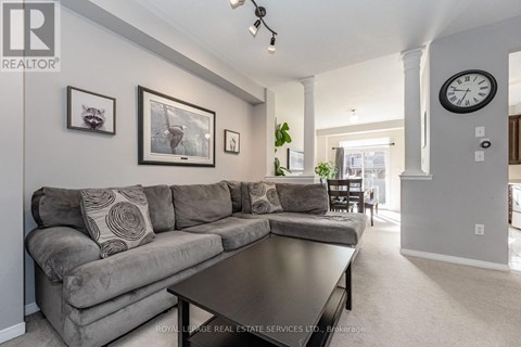 A living room with a grey couch and a coffee table.